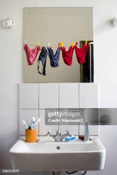 germany, hessen, frankfurt, empty bathroom with mirror reflection of underwears - pendurar imagens e fotografias de stock