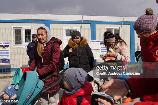 Ukrainian refugees prepare to get their passports checked at the border crossing in Romania, on March 8, 2022 in Isaccea, Romania. According to the...