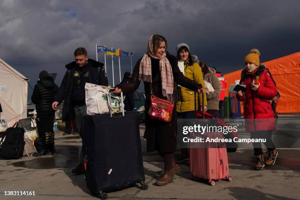 Ukrainian refugees prepare to get their passports checked at the border crossing in Romania, on March 8, 2022 in Isaccea, Romania. According to the...