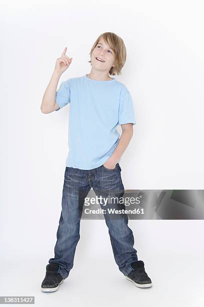 germany, bavaria, ebenhausen, boy standing against white background, smiling - boy jeans stock pictures, royalty-free photos & images