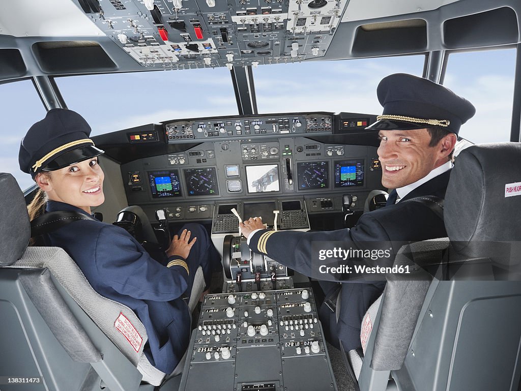 Germany, Bavaria, Munich, Pilot and co-pilot piloting aeroplane from airplane cockpit