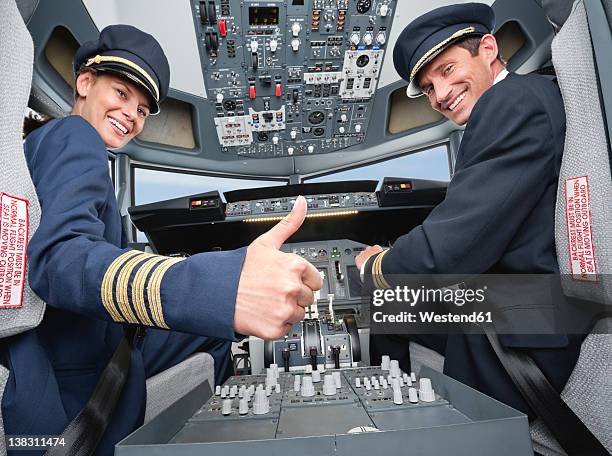 germany, bavaria, munich, pilot and co-pilot piloting aeroplane from airplane cockpit - co pilot stock pictures, royalty-free photos & images