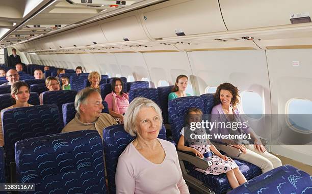 germany, munich, bavaria, people in economy class airliner - ekonomiklass bildbanksfoton och bilder