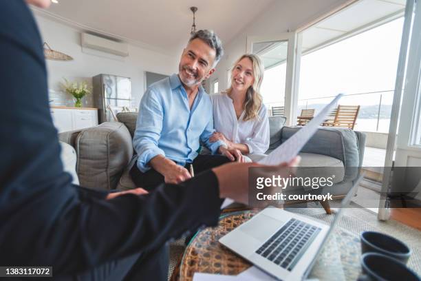 happy mature couple meeting investments and financial advisor at home. - inheritance consulting stockfoto's en -beelden