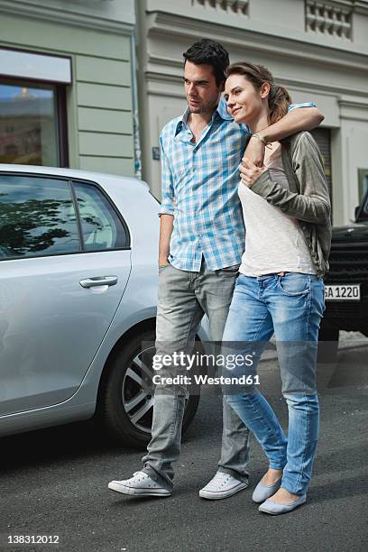 germany, berlin, couple walking hand in hand through city street - two cars side by side stock pictures, royalty-free photos & images