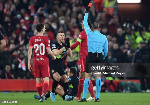 Referee Antonio Mateu Lahoz sends off Alexis Sanchez of Inter Milan as Ivan Perisic reacts during the UEFA Champions League Round Of Sixteen Leg Two...