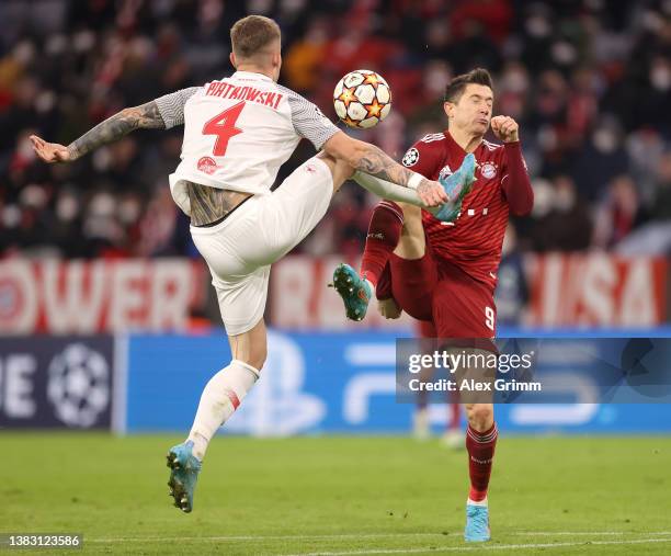 Robert Lewandowski of FC Bayern Muenchen battles for possession with Kamil Piatkowski of FC Red Bull Salzburg during the UEFA Champions League Round...