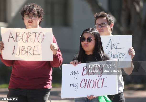 Demonstrators hold signs as they stage a protest in favor of abortion rights on the steps of Sproul Hall on the U.C. Berkeley campus on March 08,...