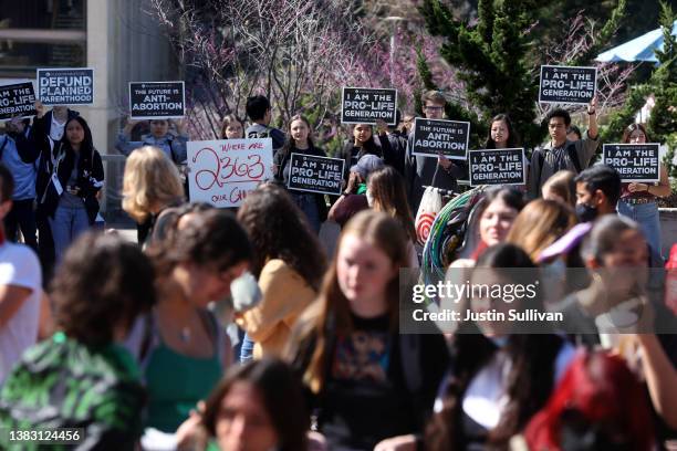 Pro-life demonstrators hold signs as they stage a counter protest to a protest in favor of abortion rights on the steps of Sproul Hall on the U.C....