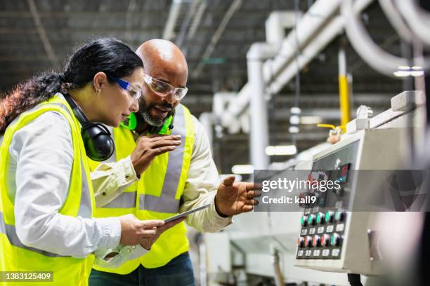 multiracial workers in factory at machine control panel - eye protection stock pictures, royalty-free photos & images