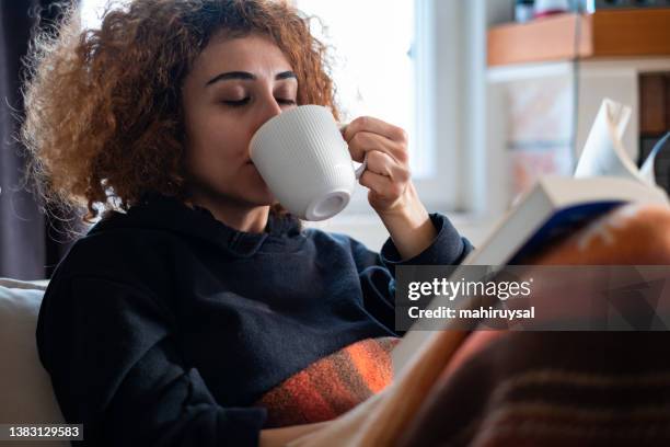 reading a book with mug of coffee - cosy autumn stock pictures, royalty-free photos & images