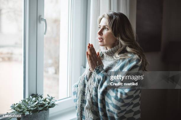 unwell woman feel cold in home with no heating - ac weary stock pictures, royalty-free photos & images