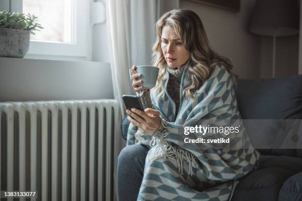 unwell woman feel cold in home with no heating - ac weary stock pictures, royalty-free photos & images