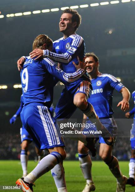 Juan Mata of Chelsea celebrates scoring his side's second goal with team mate Fernando Torres during the Barclays Premier League match between...