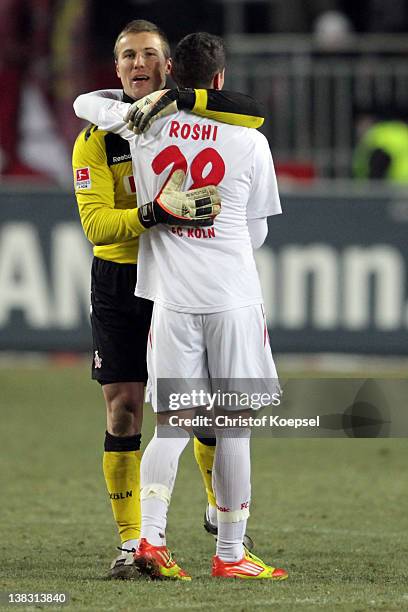 Michael Rensing embraces Odise Roshi of Koelnafter winning 1-0 the Bundesliga match between 1. FC Kaiserslautern and 1. FC Koeln at...