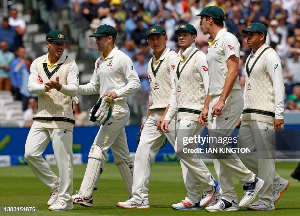 Australia's players walks back to the pavilion as they break for lunch on day five of the second Ashes cricket Test match between England and...