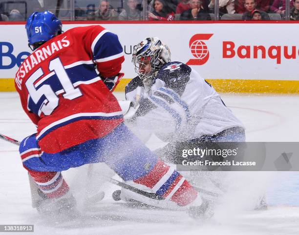 David Desharnais of the Montreal Canadiens is being stopped by goaltender Ondrej Pavelec of the Winnipeg Jets during the NHL game on February 5, 2012...