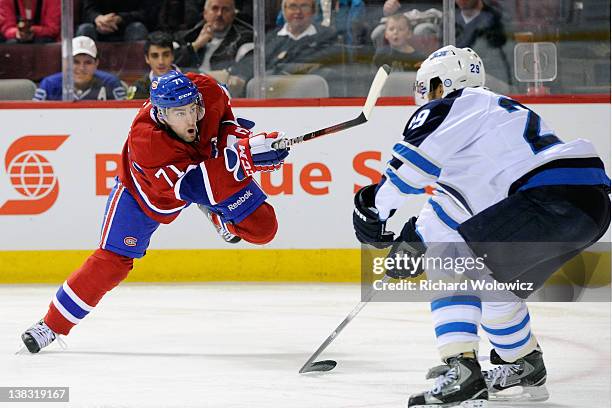 Louis Leblanc of the Montreal Canadiens shoots the puck in front of Johnny Oduya of the Winnipeg Jets during the NHL game at the Bell Centre on...