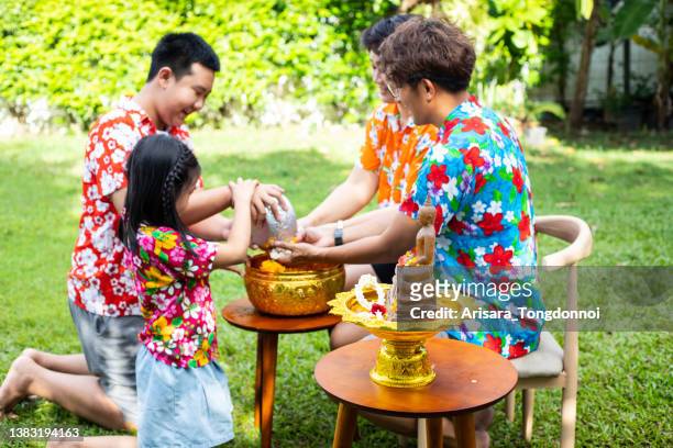 songkran festival bathe with respect to parents - songkran stock pictures, royalty-free photos & images