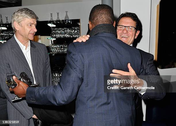 Arsene Wenger, Arsenal Football manager looks on as England Football manager Fabio Capello and Academy member Marcel Desailly embrace at the Laureus...
