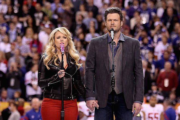 Country singers Miranda Lambert and husband Blake Shelton perform “America the Beautiful” before the start of Super Bowl XLVI at Lucas Oil Stadium on...