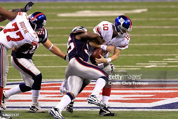 Quarterback Eli Manning of the New York Giants is sacked for a loss on third down by Mark Anderson of the New England Patriots in the first quarter...