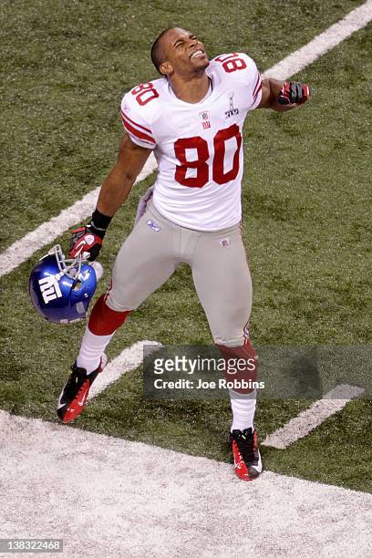 Victor Cruz of the New York Giants celebrates with his teammates after catching a two yard touchdown pass from Eli Manning in the first quarter...