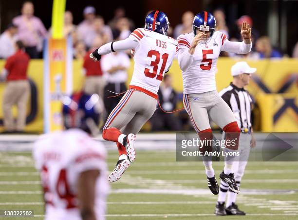 Cornerback Aaron Ross and punter Steve Weatherford of the New York Giants celebrate after a punt in the second quarter against the New England...