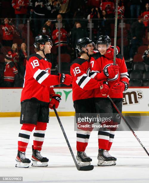 Dawson Mercer, Jack Hughes and Yegor Sharangovich of the New Jersey Devils celebrate their 5-3 victory over the Colorado Avalanche at the Prudential...