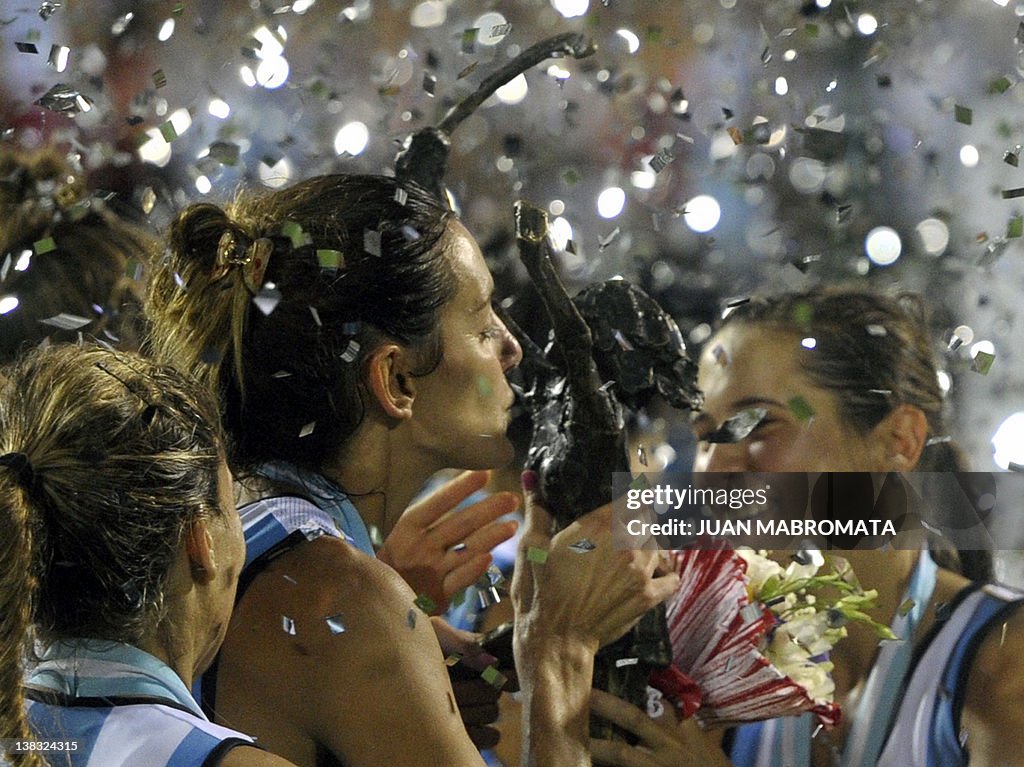 Argentina's Luciana Aymar (C) kisses the