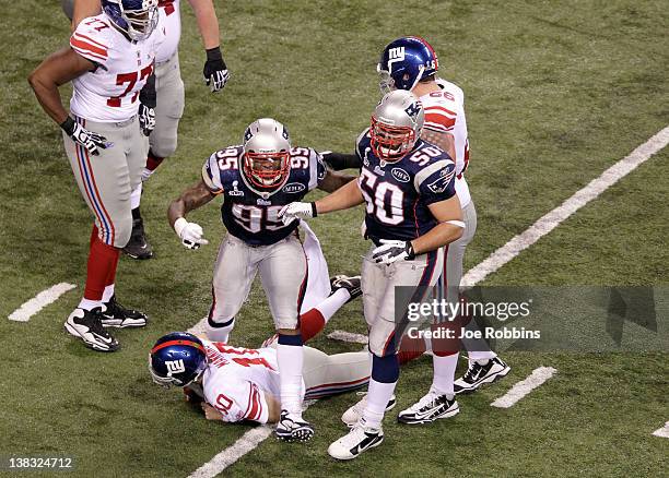 Rob Ninkovich and Mark Anderson of the New England Patriots celebrate after sacking Eli Manning of the New York Giants on third down for a loss of...