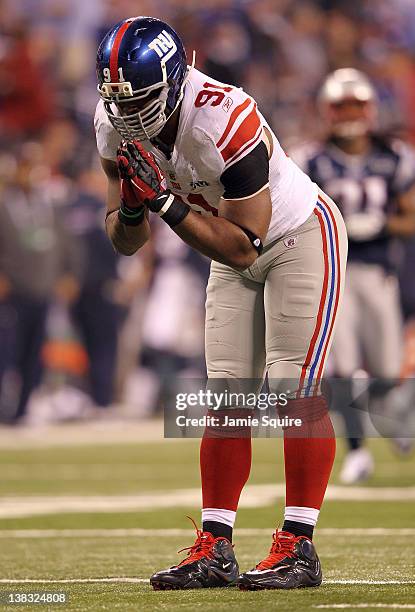 Defensive end Justin Tuck of the New York Giants celebrates after sacking Tom Brady of the New England Patriots in the third quarter during Super...