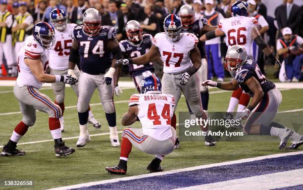 Runningback Ahmad Bradshaw of the New York Giants runs the ball for a 6 yard touchdown in the fourth quarter against the New England Patriots during...