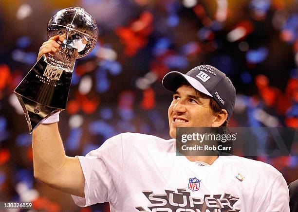 Quarterback Eli Manning of the New York Giants poses with the Vince Lombardi Trophy after the Giants defeated the Patriots by a score of 21-17 in...