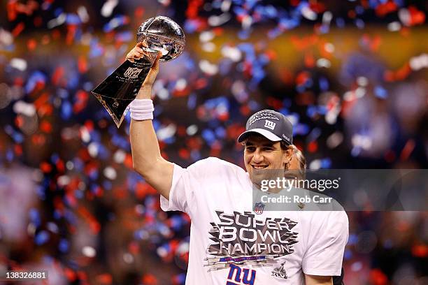 Quarterback Eli Manning of the New York Giants poses with the Vince Lombardi Trophy after the Giants defeated the Patriots by a score of 21-17 in...