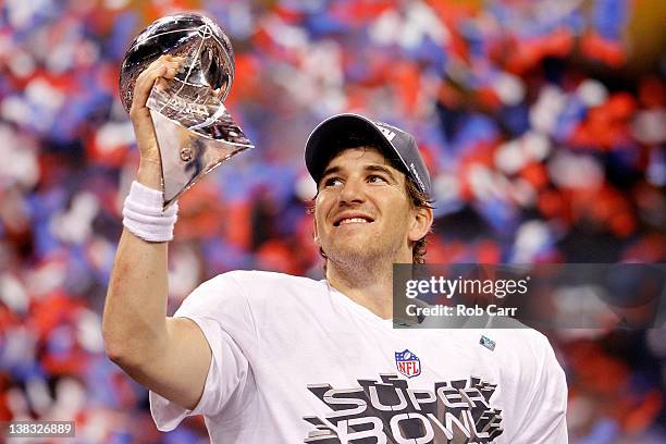 Quarterback Eli Manning of the New York Giants poses with the Vince Lombardi Trophy after the Giants defeated the Patriots by a score of 21-17 in...