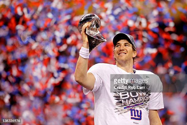 Quarterback Eli Manning of the New York Giants poses with the Vince Lombardi Trophy after the Giants defeated the Patriots by a score of 21-17 in...