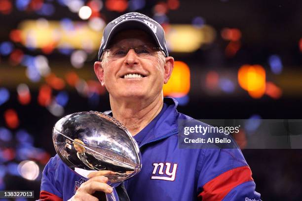 Head coach Tom Coughlin of the New York Giants celebrates with the Vince Lombardi Trophy after defeating the New England Patriots in Super Bowl XLVI...