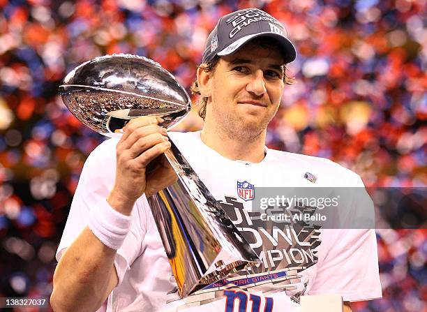 Eli Manning of the New York Giants hoist the Vince Lombardi Trophy after defeating the New England Patriots in Super Bowl XLVI at Lucas Oil Stadium...