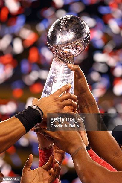 The New York Giants hoist the Vince Lombardi Trophy after defeating the New England Patriots in Super Bowl XLVI at Lucas Oil Stadium on February 5,...