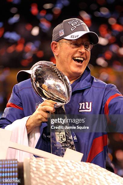 Head coach Tom Coughlin of the New York Giants celebrates with the Vince Lombardi Trophy after defeating the New England Patriots in Super Bowl XLVI...