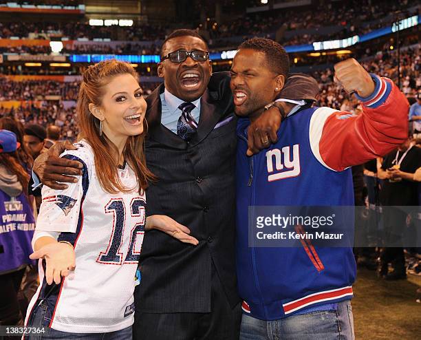 Personality Maria Menounos, and A.J. Calloway pose with former NFL player and broadcaster Michael Irvin attend the Bridgestone Super Bowl XLVI...