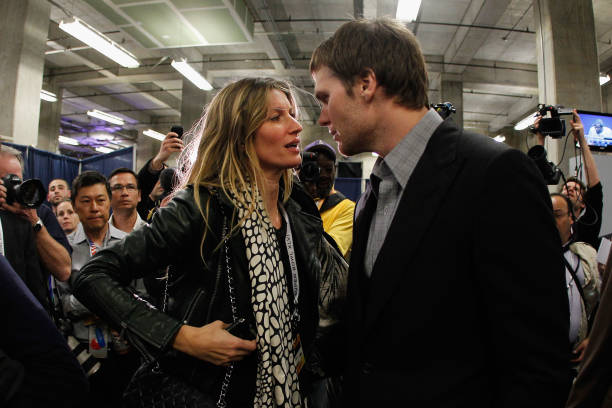 Tom Brady of the New England Patriots chats with his wife Gisele Bundchen after losing to the New York Giants by a score of 21-17 in Super Bowl XLVI...