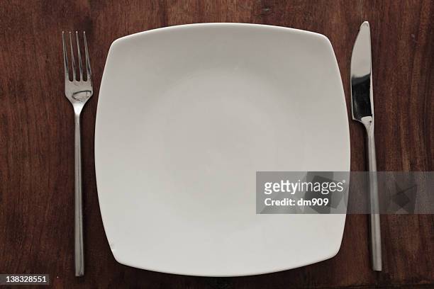 white plate with fork and knife - piatto quadrato foto e immagini stock