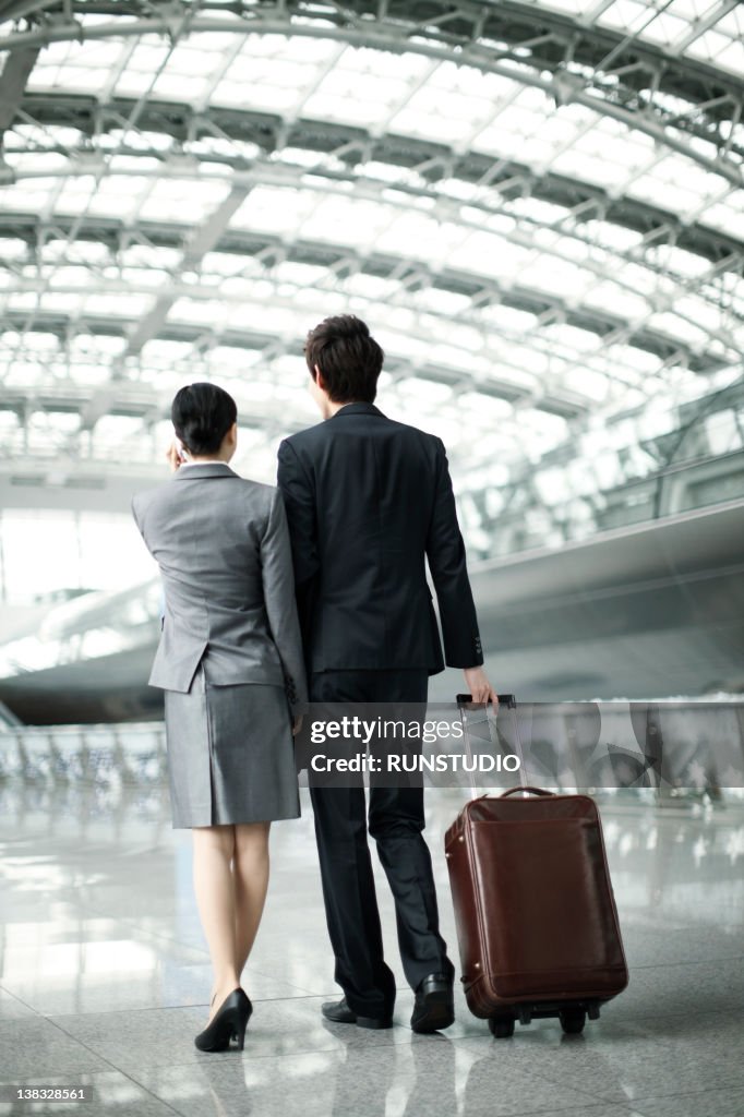 Businessman and woman walking and talking