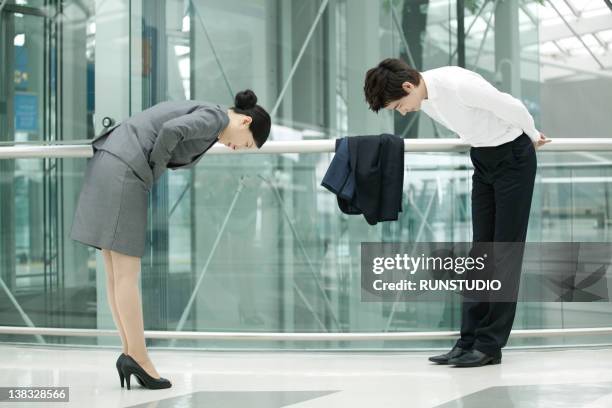 businessman &businesswoman greeting each other - welcome korean stock pictures, royalty-free photos & images