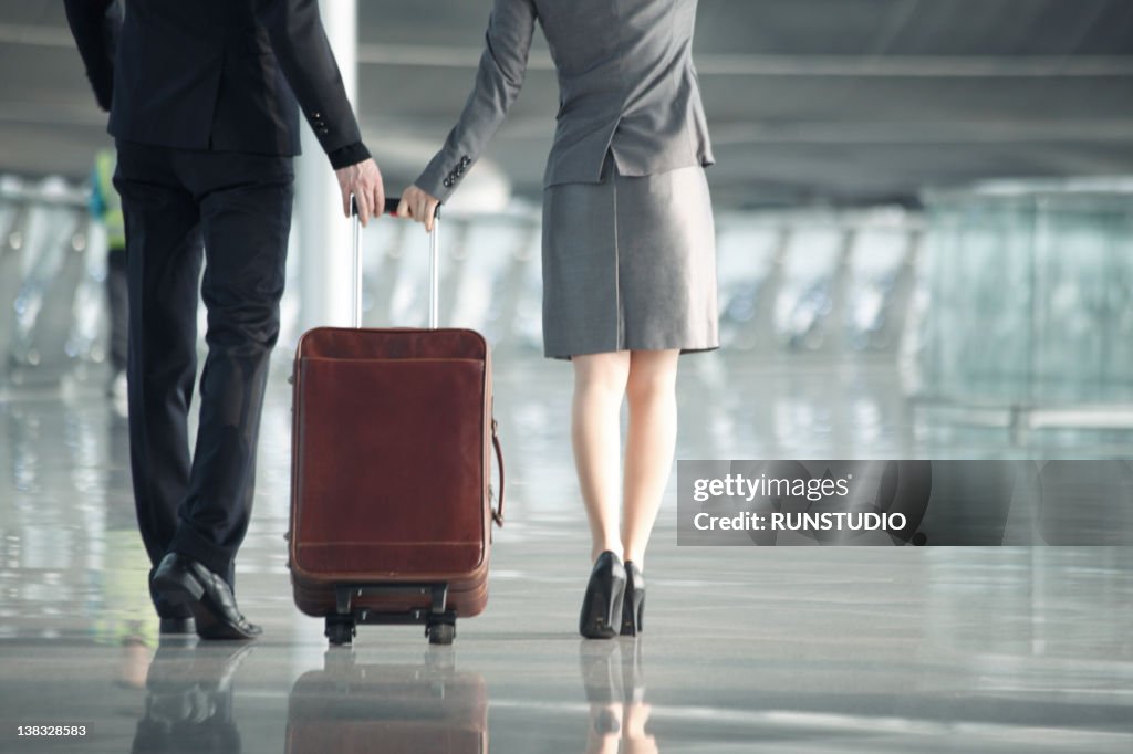 Businessman&businesswoman with luggage