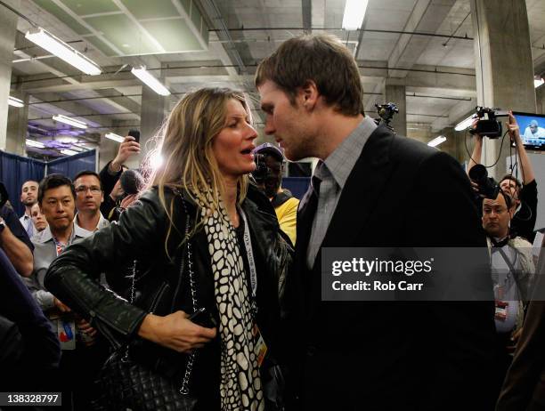 Tom Brady of the New England Patriots chats with his wife Gisele Bundchen after losing to the New York Giants by a score of 21-17 in Super Bowl XLVI...