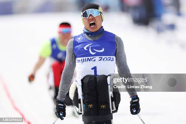 Zheng Peng of Team China celebrates winning the gold medal in the Men's Sprint Sitting Final on day five of the Beijing 2022 Winter Paralympics at...