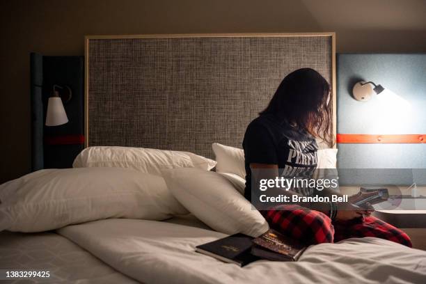 Munique Liggens prepares for bed in her hotel room on March 08, 2022 in Montgomery, Alabama. "I traveled here from Texas to be a voice for those...